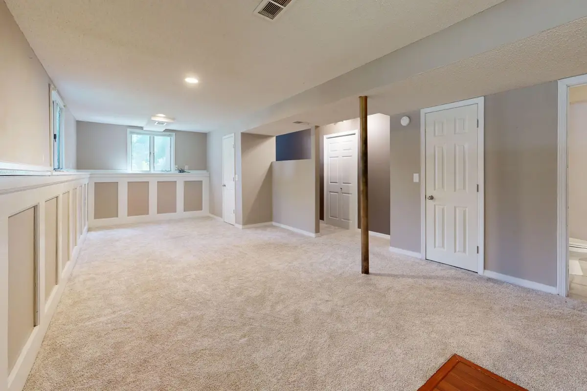 Finished basement with carpet, recessed lighting and painted walls